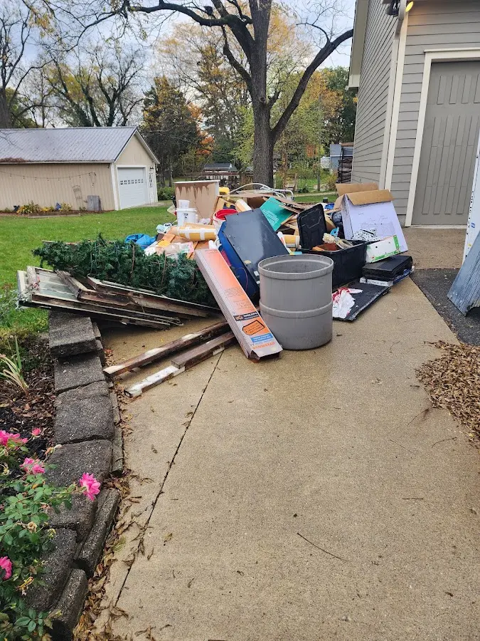 Dumpster being loaded with debris for 12 Yard Dumpster Rental in Mayo